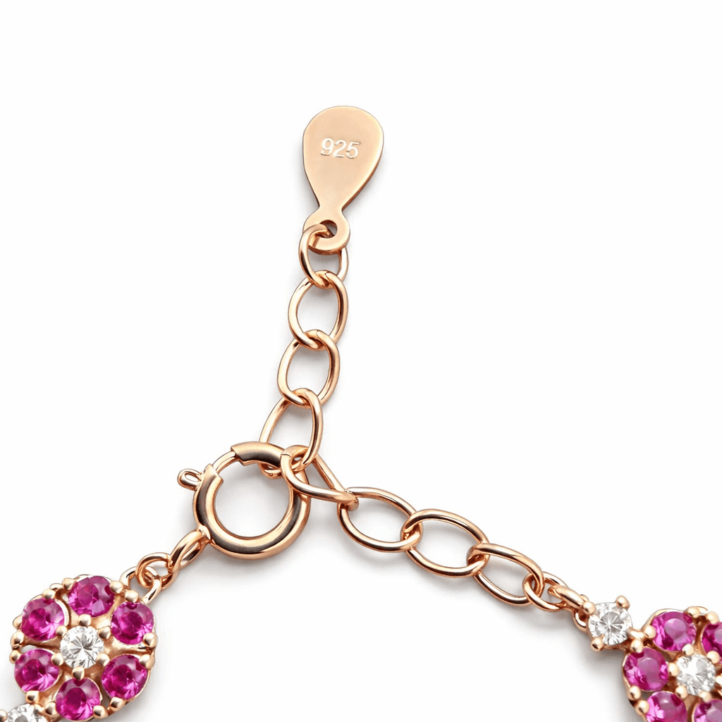 Elegant Gold Tone Floral Bracelet with Pink Stone Cluster Design